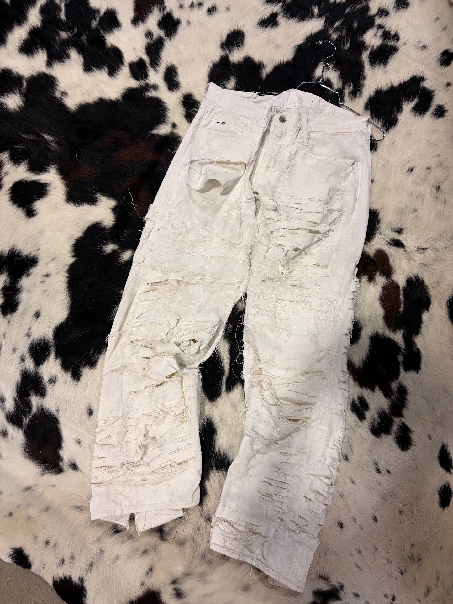 Thrashed/coated bootcut jeans